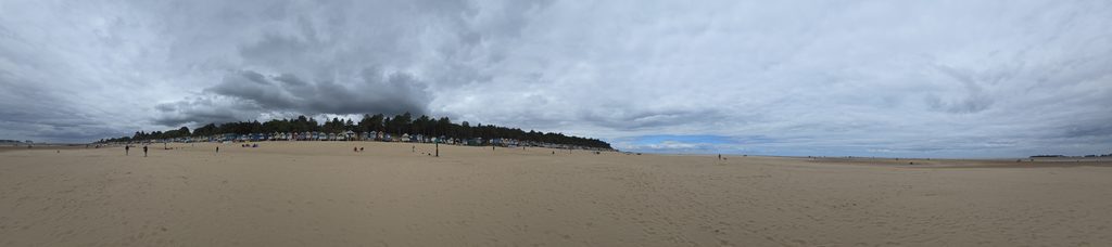 Panoramic view of Wells-next-the-Sea beach and colourful beach huts in Norfolk
